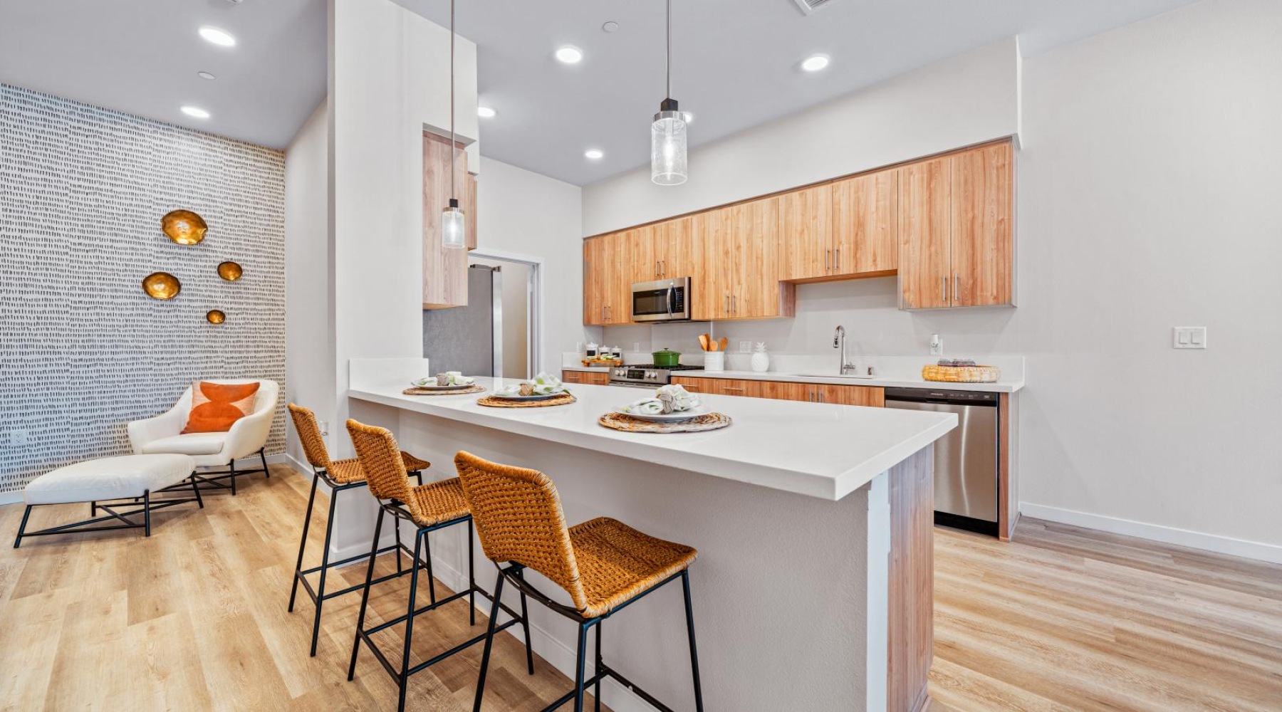 Spacious kitchens with thoughtful details a kitchen with a dining table and chairs